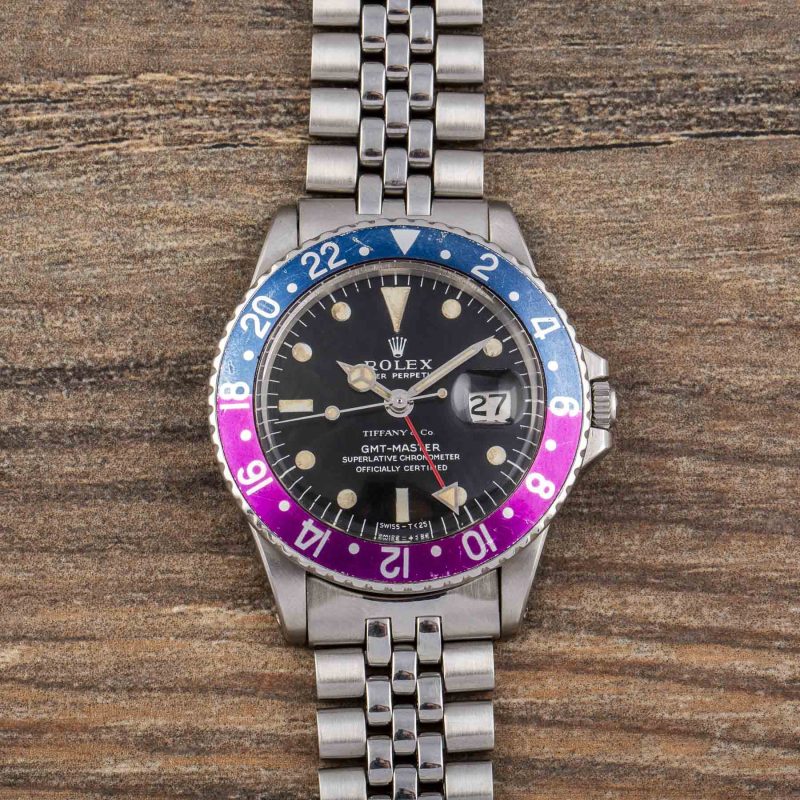 Rolex GMT-MASTER REF. 1675 RETAILED BY TIFFANY & CO. WITH “LONG E “ DIAL AND FUCHSIA BEZEL IN STAINLESS STEEL